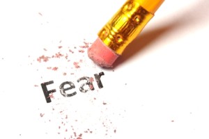 fear concept with word eraser and pencil on white background